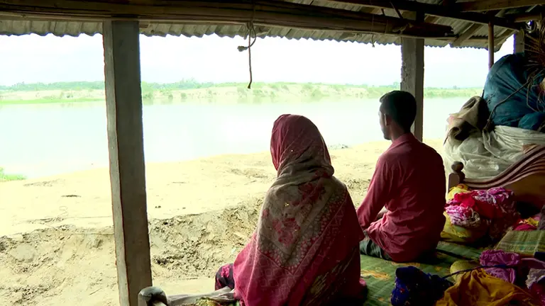 ভাঙা ঘরে চৌকিতে বসে অপলক দৃষ্টিতে ব্রহ্মপুত্রের দিকে তাকিয়ে এই পরিবার 